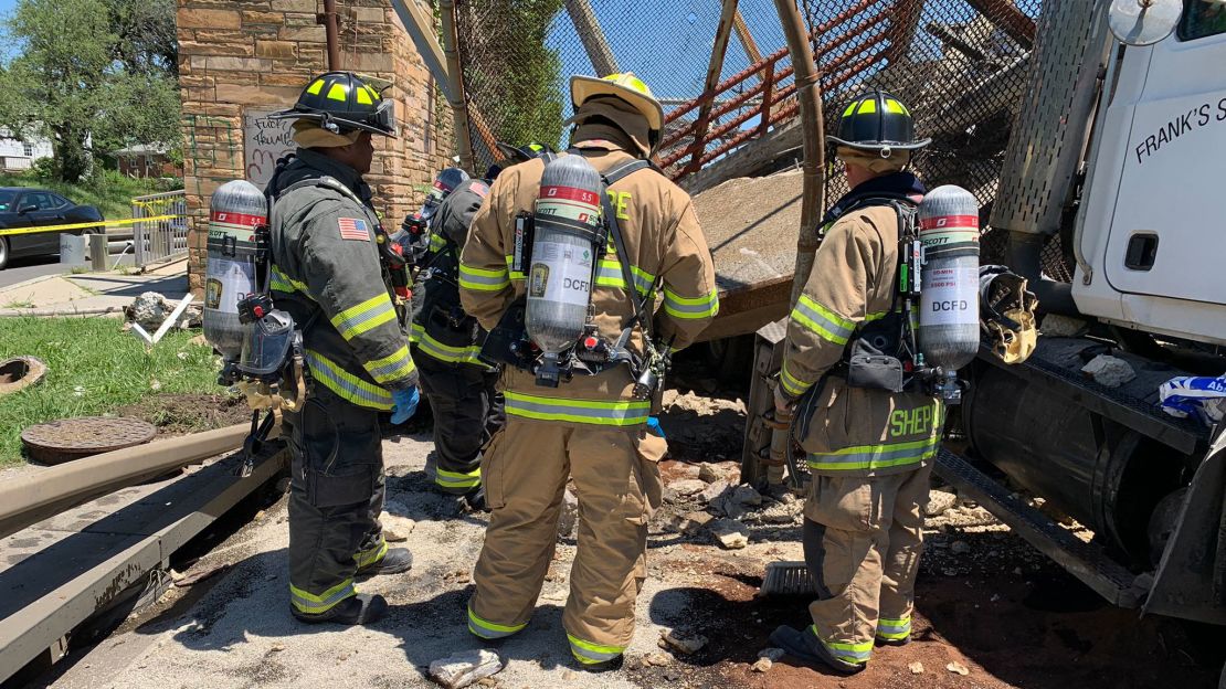 Firefighters investigate the scene on Wednesday.