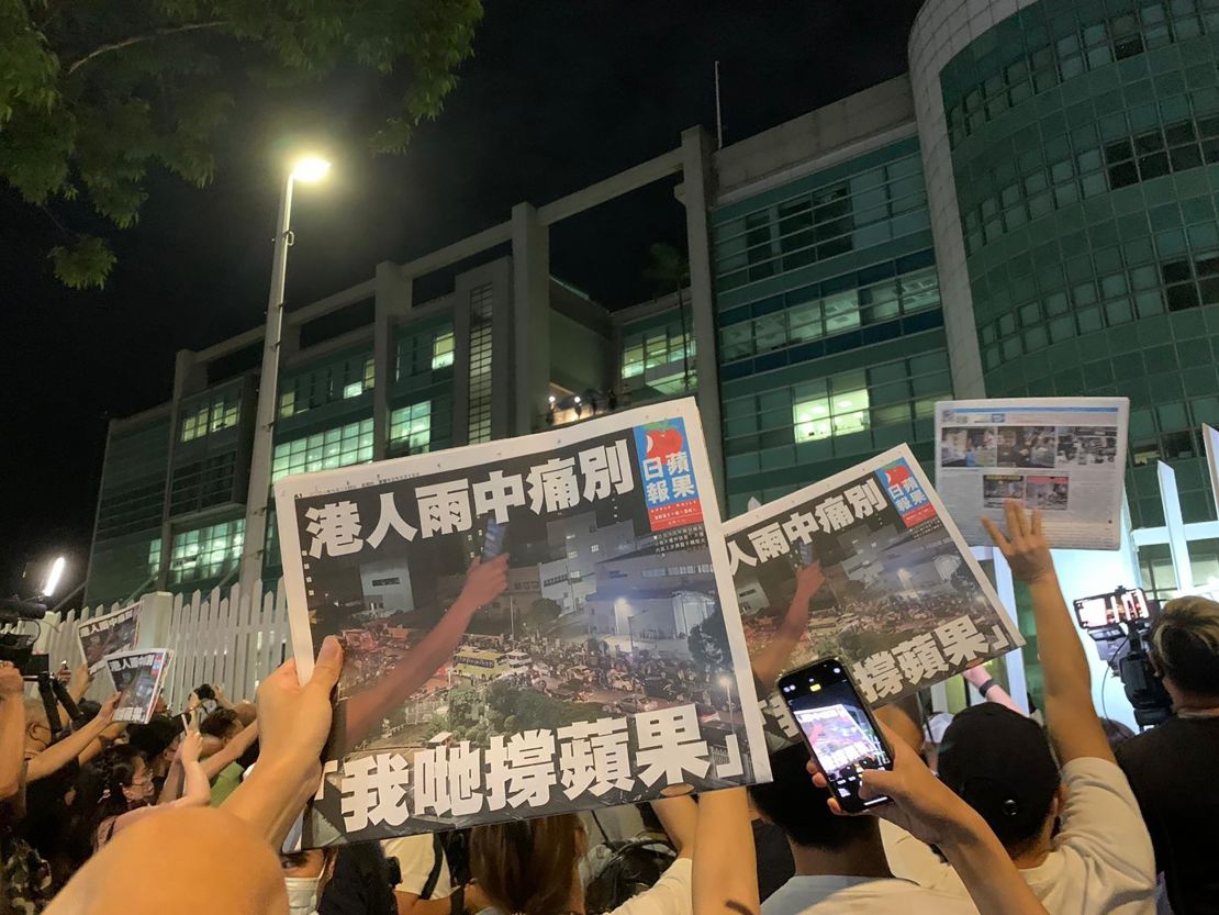 Free copies of the final Apple Daily issue being handed out to supporters through the gates in Hong Kong on July 23.