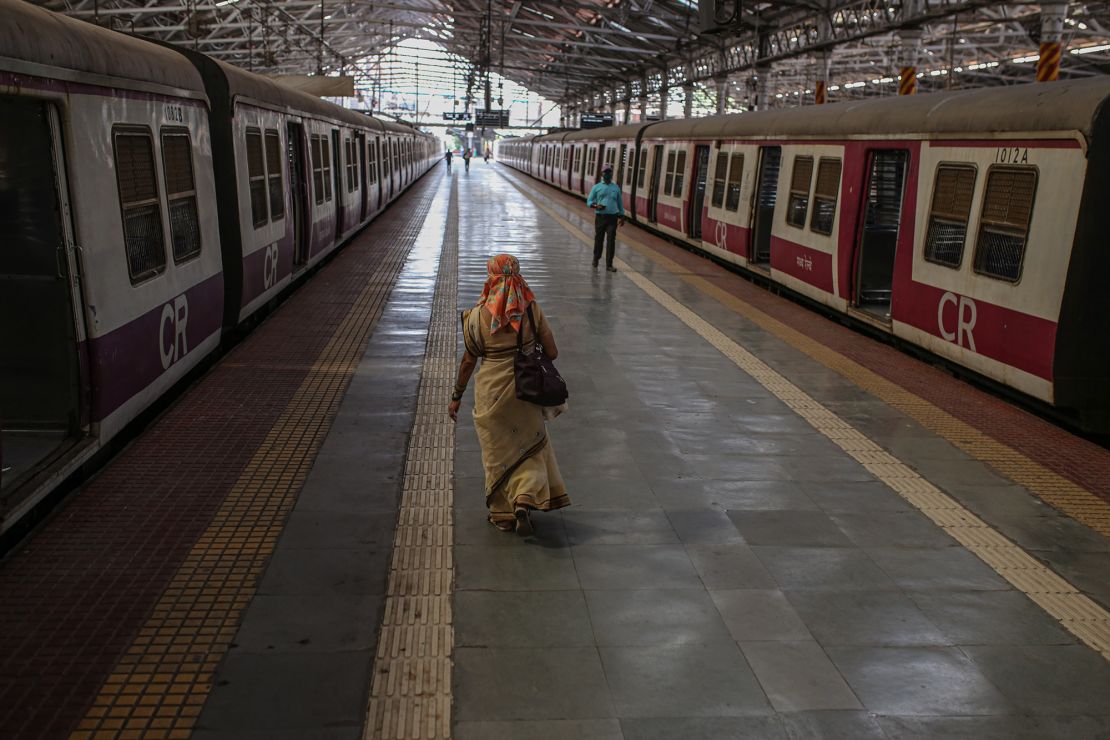People walk along a platform at the Chhatrapati Shivaji Maharaj Terminus train station during a lockdown in Mumbai, India, on Tuesday, April 27, 2021. 