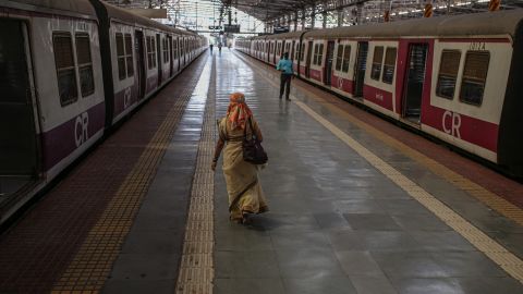 People walk along a platform at the Chhatrapati Shivaji Maharaj Terminus train station during a lockdown in Mumbai, India, on Tuesday, April 27, 2021.