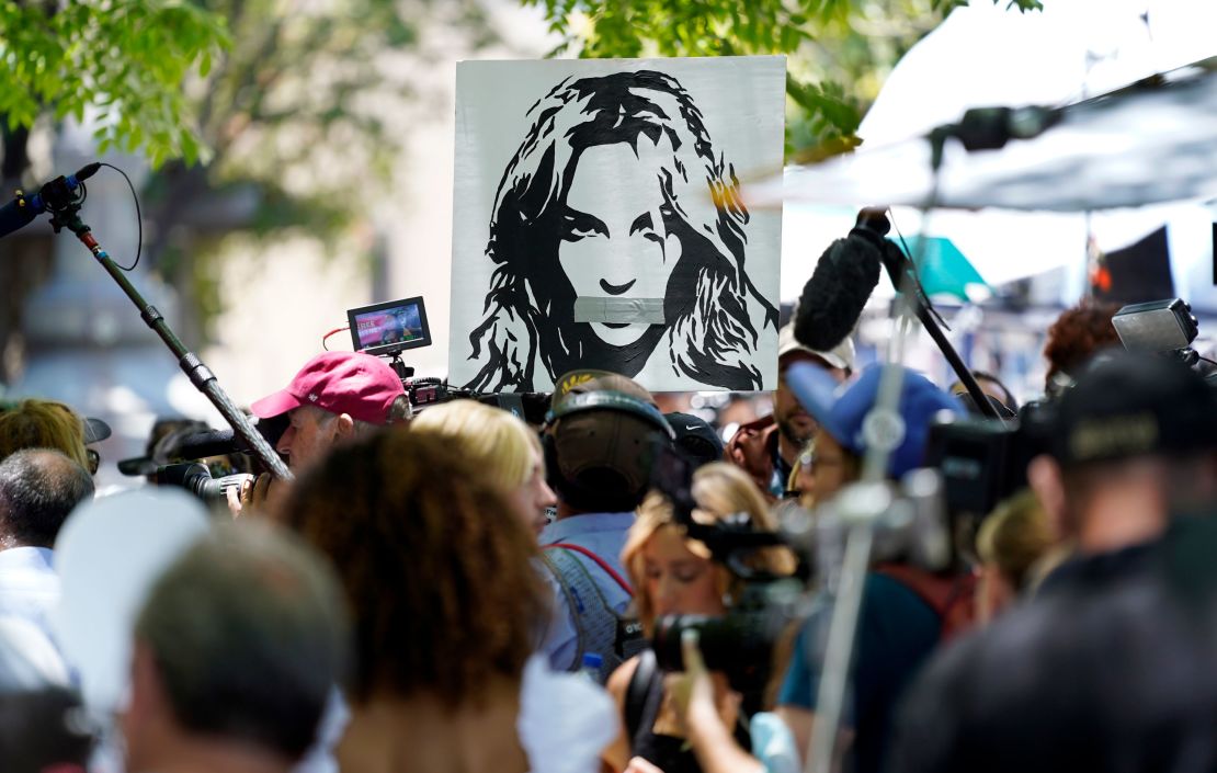 A portrait of Britney Spears looms over supporters and media members outside the court hearing concerning the singer's conservatorship at the Stanley Mosk Courthouse on Wednesday, June 23, in Los Angeles. 