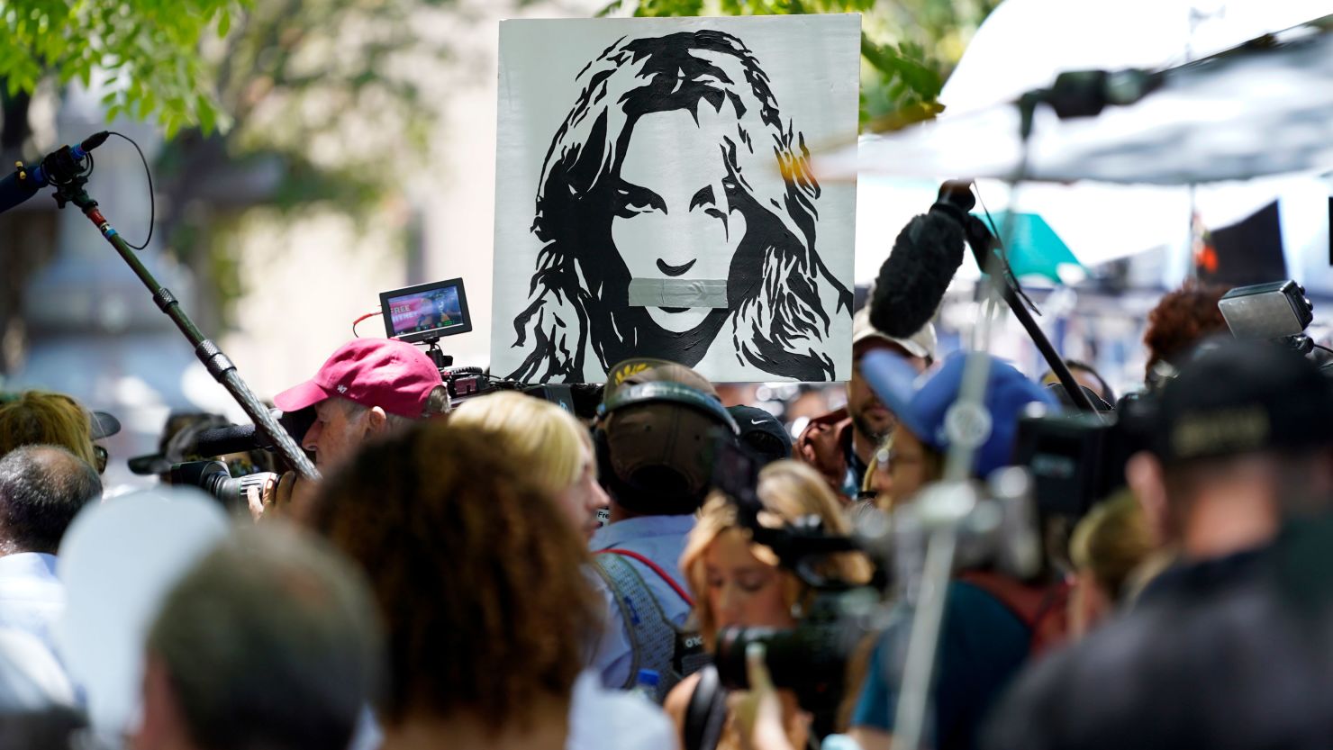 Supporters hold a portrait of Britney Spears at a rally in Los Angeles on June 23 outside a court hearing regarding the pop singer's conservatorship.