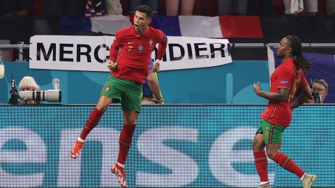 Ronaldo celebrates with teammate Renato Sanches after scoring his side's second goal against France.
