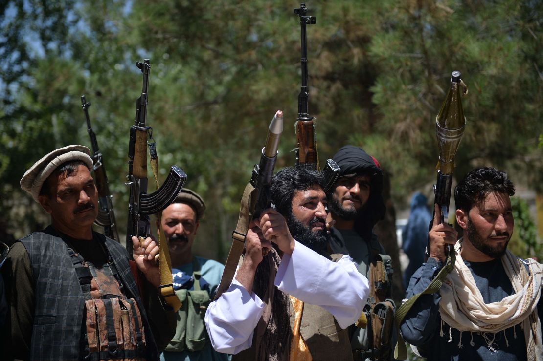 People gather with guns to support Afghanistan security forces against the Taliban, in Guzara district, Herat province on June 23.