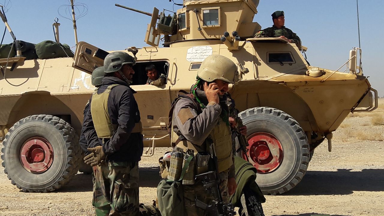 Afghan security forces stand near an armoured vehicle during ongoing fighting between Afghan security forces and Taliban fighters in the Busharan area on the outskirts of Lashkar Gah, the capital city of Helmand province May 5, 2021. - American warplanes were backing Afghan forces against a major Taliban offensive in the south of the country even as the US military pressed on with a troop withdrawal, officials said on May 5. Fierce fighting has erupted in Helmand province since the weekend, when the US military formally began withdrawing its remaining troops. (Photo by Sifatullah ZAHIDI / AFP) (Photo by SIFATULLAH ZAHIDI/AFP via Getty Images)