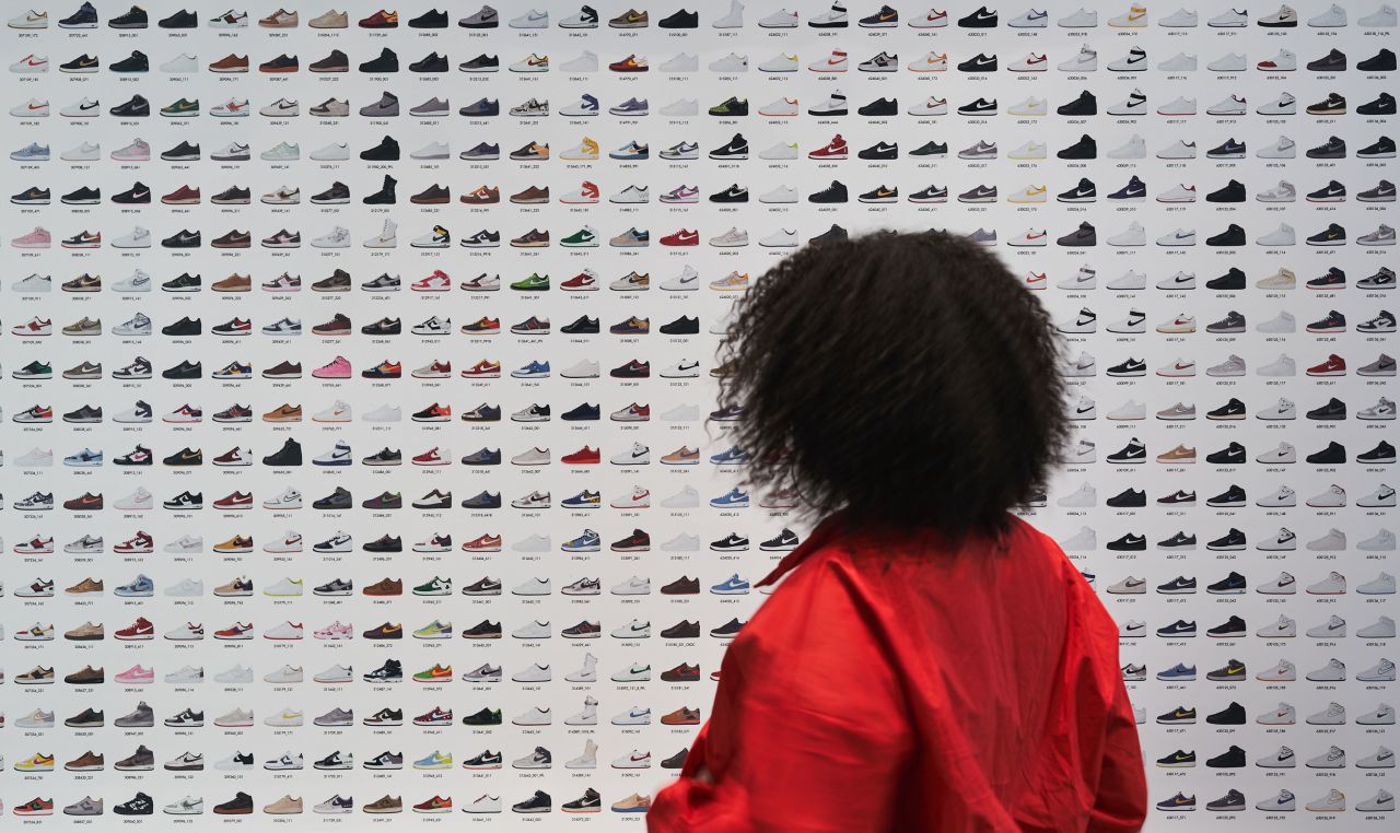 A visitor stands in front of a display at the London Design Museum's exhibit "Sneakers Unboxed."