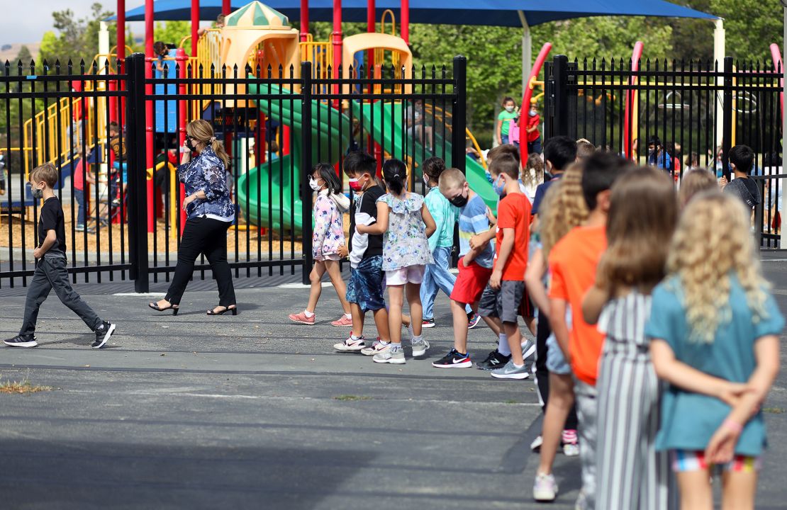 Teacher Nusheen Saadat, second from left, leads students across campus during a summer school session June 14 at Golden View Elementary School in San Ramon, California.
