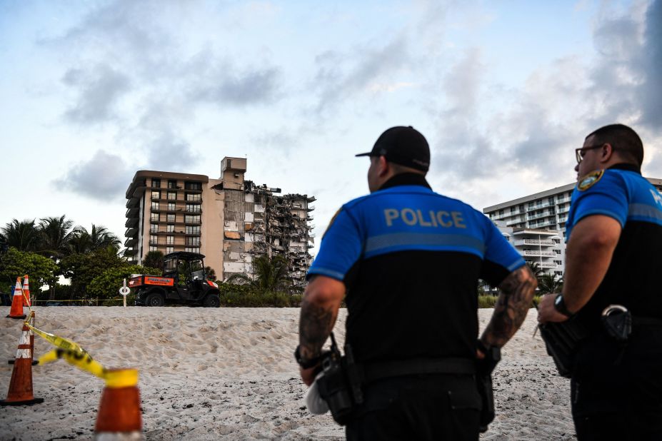 Police stand guard on the day the building collapsed.