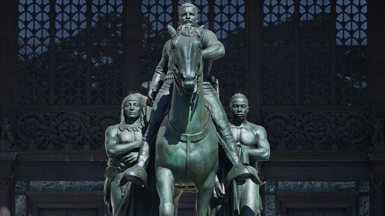 The Theodore Roosevelt Equestrian Statue, which sits in front of the The American Museum of Natural History, features Roosevelt on horseback towering over a Native American man and an African man.
