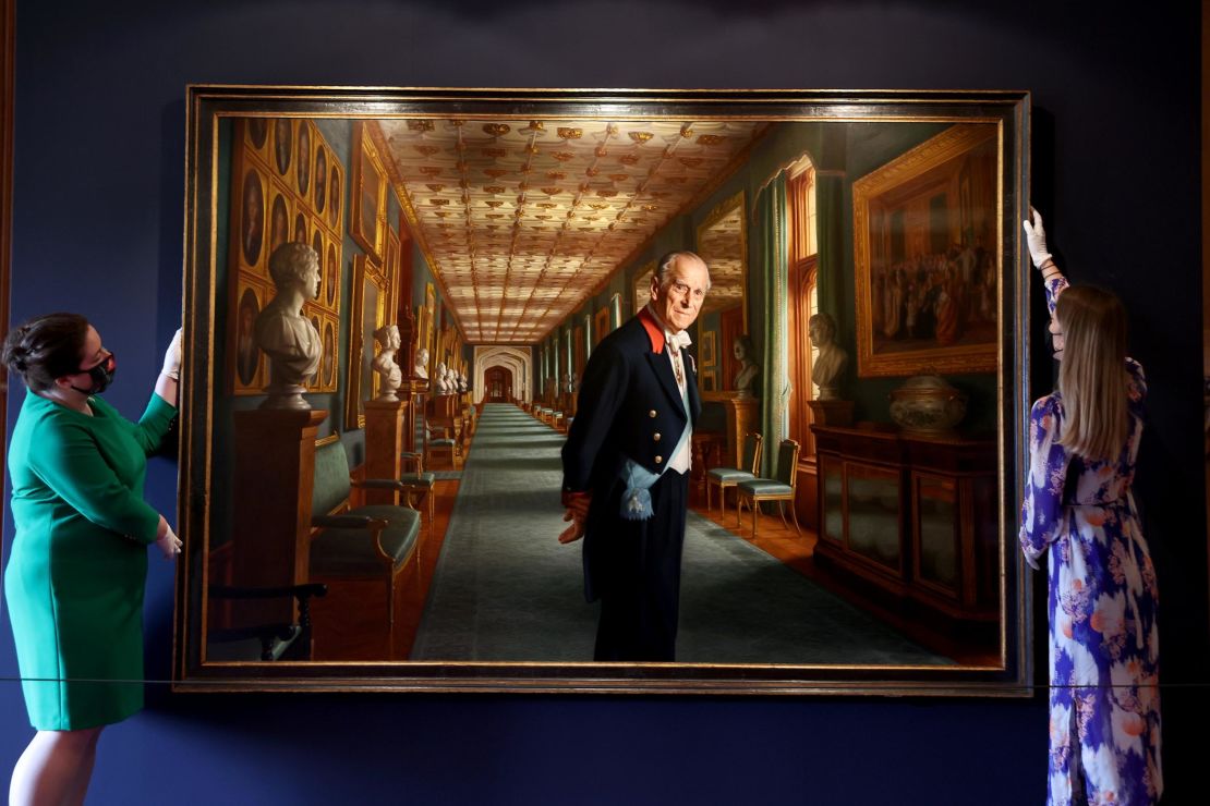 Curators adjust a portrait of Prince Philip by the artist Ralph Heimans in the Great Hall of Windsor Castle.