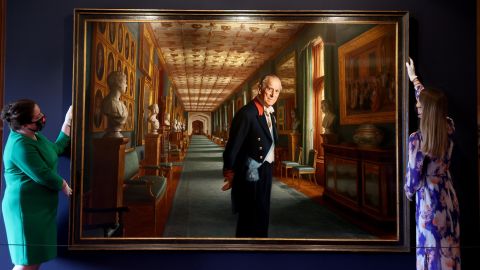 Curators adjust a portrait of Prince Philip by the artist Ralph Heimans in the Great Hall of Windsor Castle.