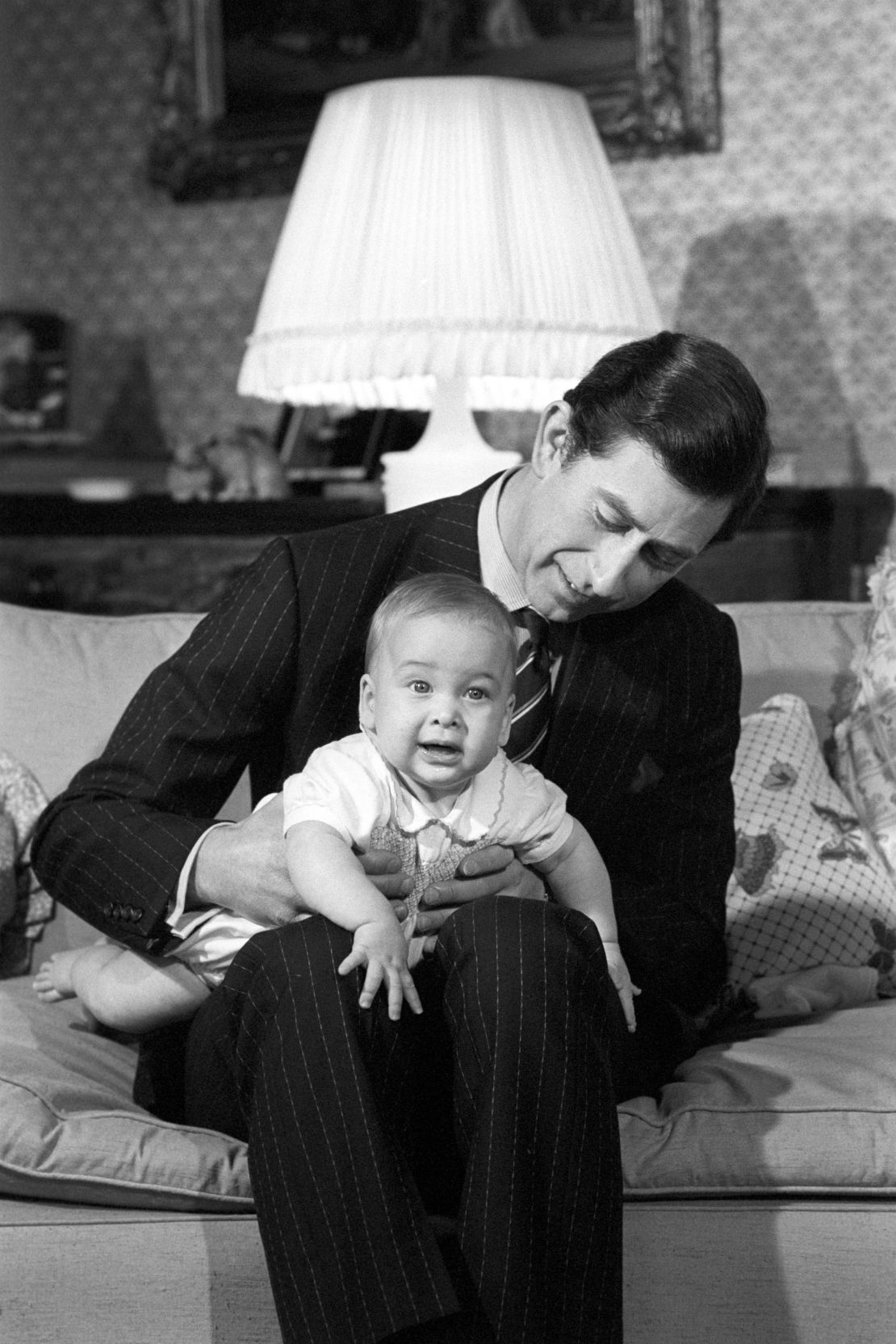 Prince Charles cradles his son Prince William at Kensington Palace in 1982.