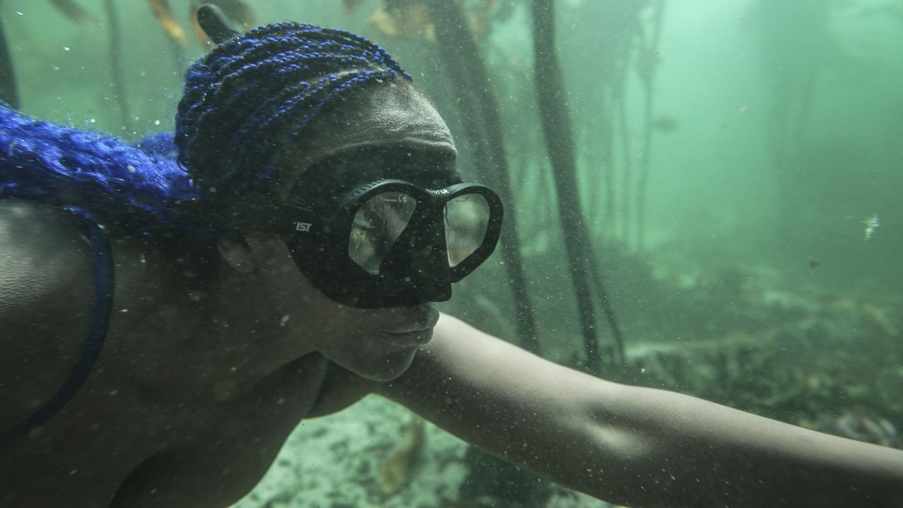It wasn't until an impulsive snorkel trip in 2016 that Ndhlovu would discover her love for the ocean: "It was just the most incredible moment when I stopped panicking from thinking that I was drowning and just realizing the incredible world that was under there." Here, she dives in the waters off Cape Town.