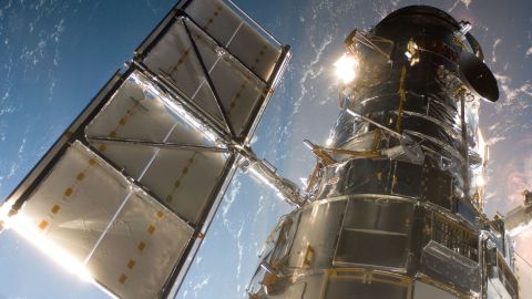 A Servicing Mission 4 crew member took this photo of the Hubble telescope just after the Space Shuttle Atlantis captured it with its robotic arm on May 13, 2009, beginning the mission to upgrade and repair the telescope.