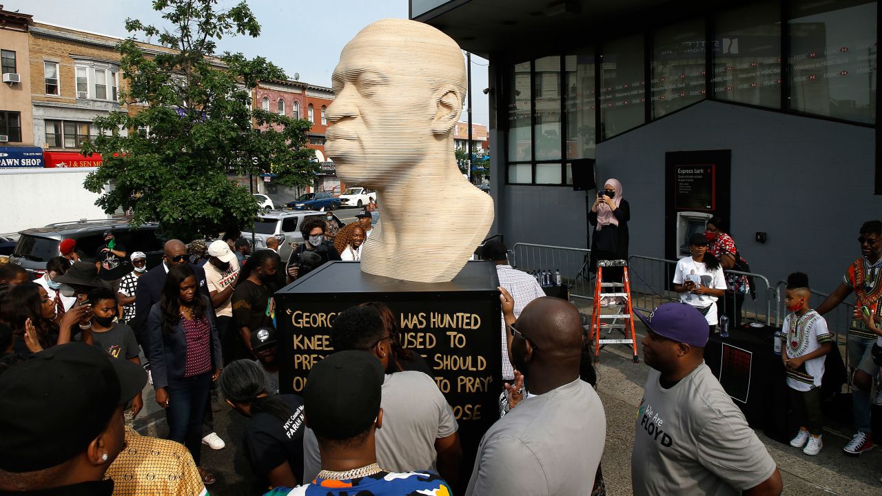 People gather during the unveiling of the George Floyd statue in the Flatbush neighborhood of Brooklyn on June 19, 2021.