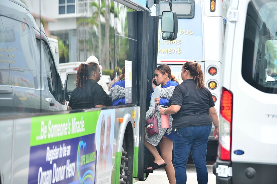 Displaced residents are taken to a nearby hotel in Surfside.