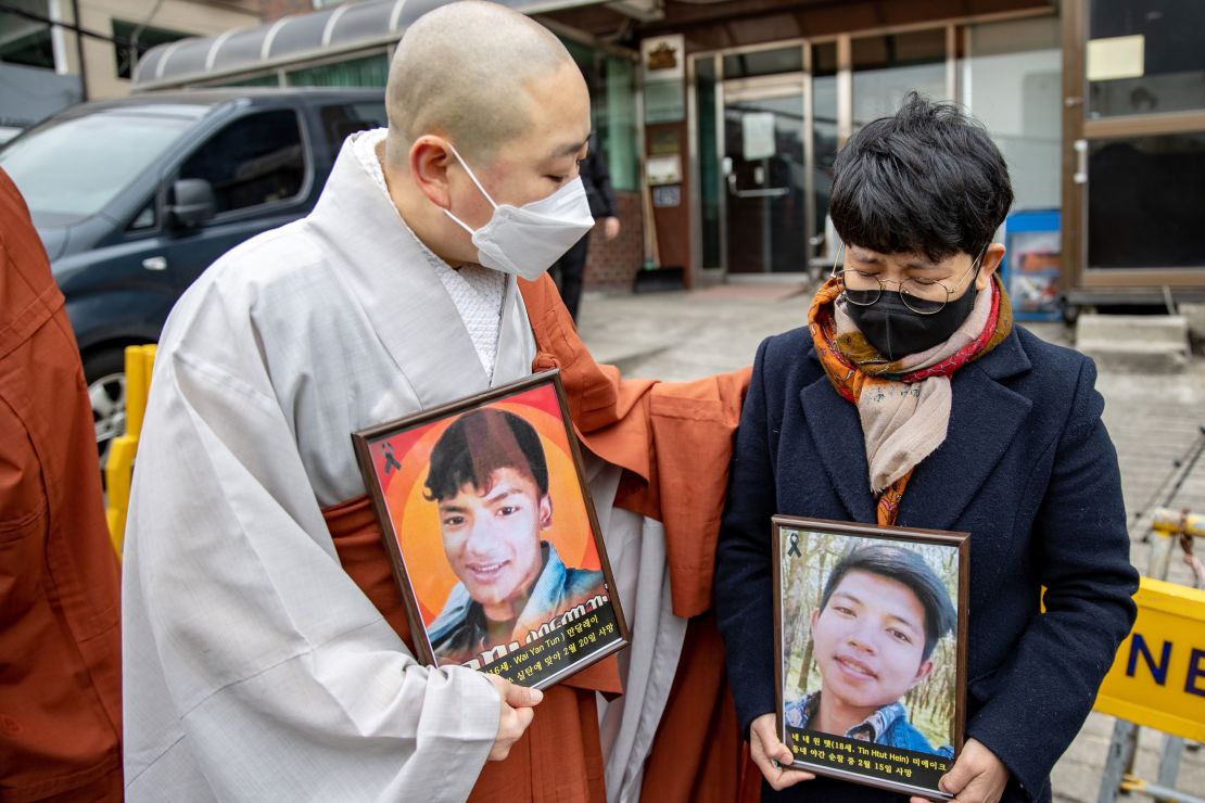 A South Korean monk comforts Myanmar national who cries in front of the Myanmar Embassy on February 25, 2021 in Seoul, South Korea during protests against the military coup in Myanmar.