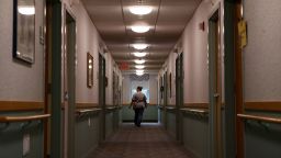 MARLBOROUGH, MA - AUGUST 19: LPN Kelly O'Hare passes down a residents hallway at St. Chretienne Retirement Residence, a home for Catholic nuns in Marlborough, MA on August 19, 2020. Since COVID-19 spread through the facility in April the chapel has been closed, leaving the residents to watch Mass on television. At St. Chretienne Retirement Residence, a home for Catholic nuns in Marlboro, 22 of 31 nuns contracted the coronavirus -- and administrator Jackeline Bones, who is also a nurse, packed a suitcase and moved into the facility, along with another nurse. Exhausted, Bones eventually became sick herself with COVID-19. The few healthy nuns, some in their 80s, pitched in to serve meals, wash sheets, and collect trash. (Photo by Craig F. Walker/The Boston Globe via Getty Images)