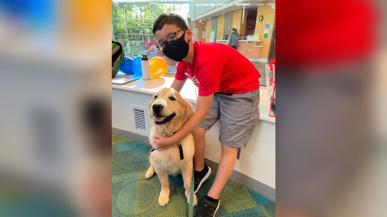Brody Parker is shown with one of the therapy dogs that visit the Children's Healthcare of Atlanta hospitals.