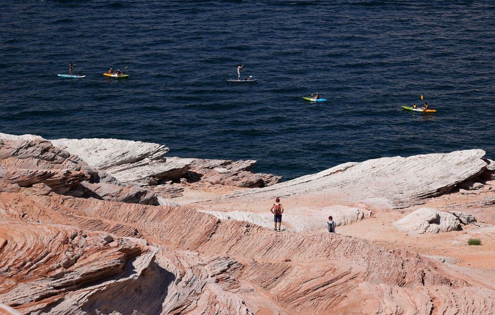 Kayakers navigate the waters of Lake Powell in Page, Arizona, on June 24.