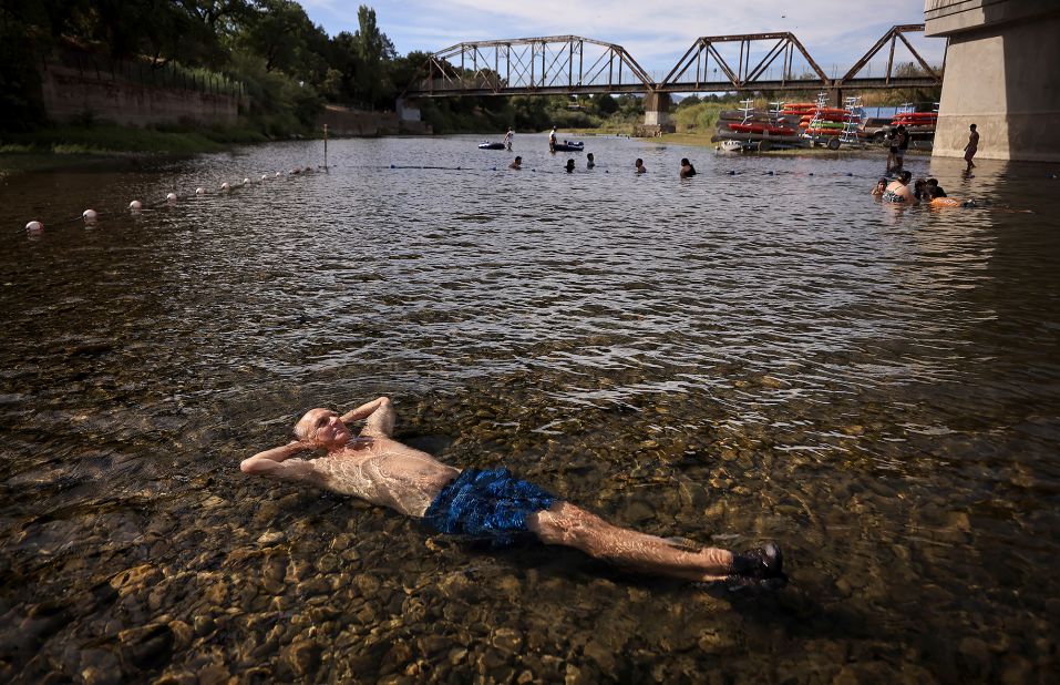 Gerry Huddleston cools off in the shallow water of the Russian River in Healdsburg, California, on June 16.