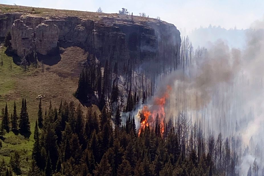 A wildfire burns on a canyon wall south of St. Xavier, Montana, on June 15. Record-high temperatures and gusting winds stoked a rapid expansion of major fires across central and eastern Montana.