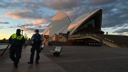 SYDNEY, AUSTRALIA - JUNE 26: Police officers walk past The Sydney Opera House during the first day of lockdown in Sydney, Australia, Saturday, June 26, 2021. The Australian state of New South Wales (NSW) on Friday announced COVID-19 lockdown in the capital Sydney after a new wave of COVID-19 outbreak in the city. (Photo by Steven Saphore/Anadolu Agency via Getty Images)