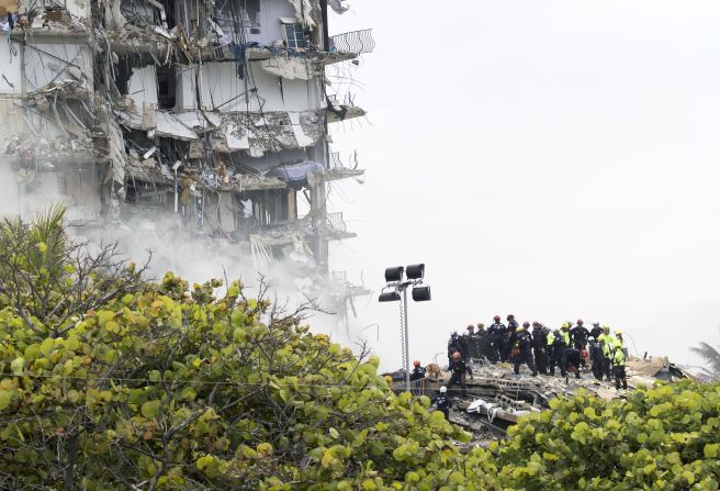 Rescue personnel search through the building's rubble on June 25.