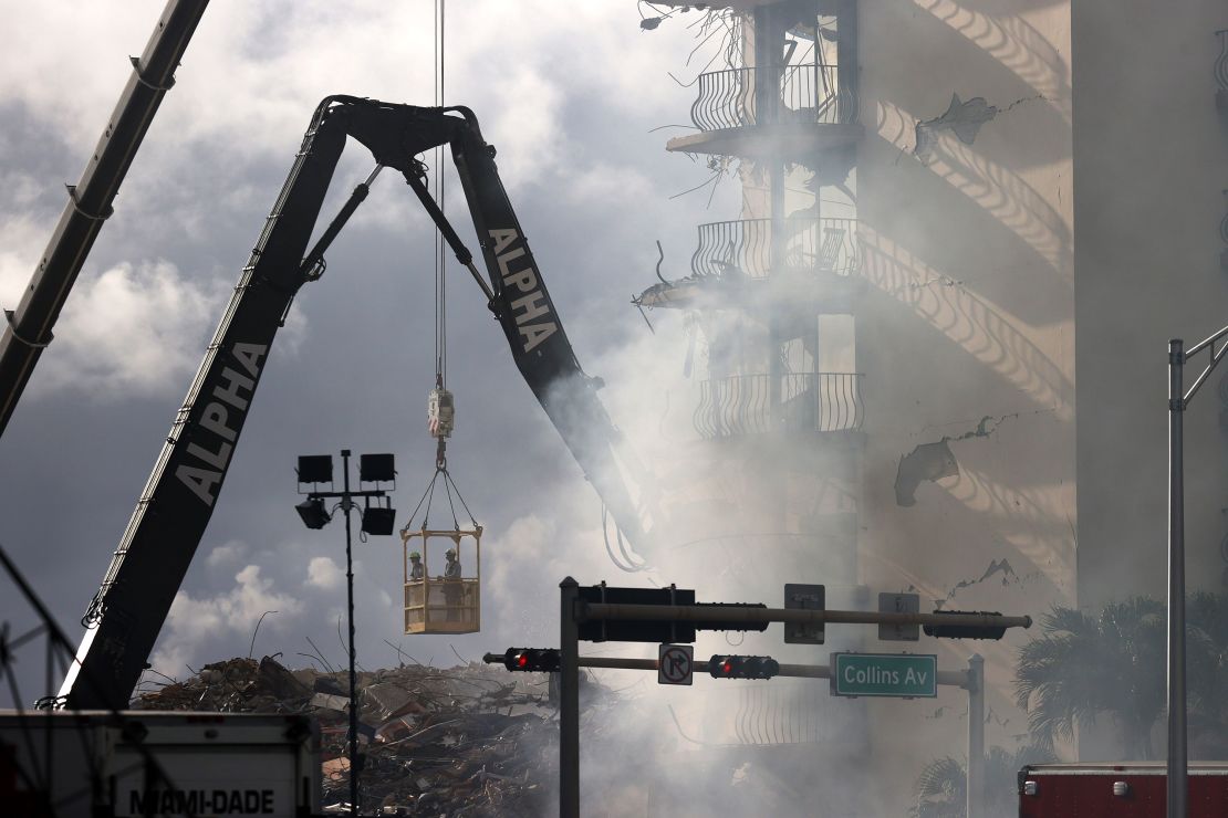 Search and rescue personnel work to find any survivors or casualties in the partially collapsed 12-story Champlain Towers South condo in Surfside, Florida.