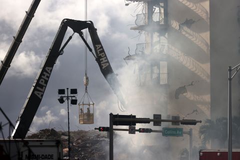 Smoke rises as rescuers continued to search for survivors on June 26.