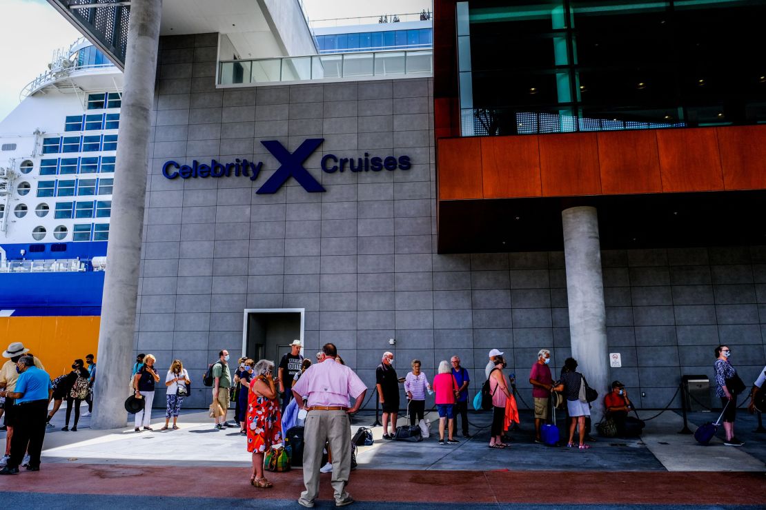 Passengers wait in line to board Celebrity Edge on June 26, 2021.