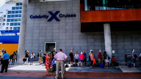 Passengers wait in line to board Celebrity Edge on June 26, 2021.