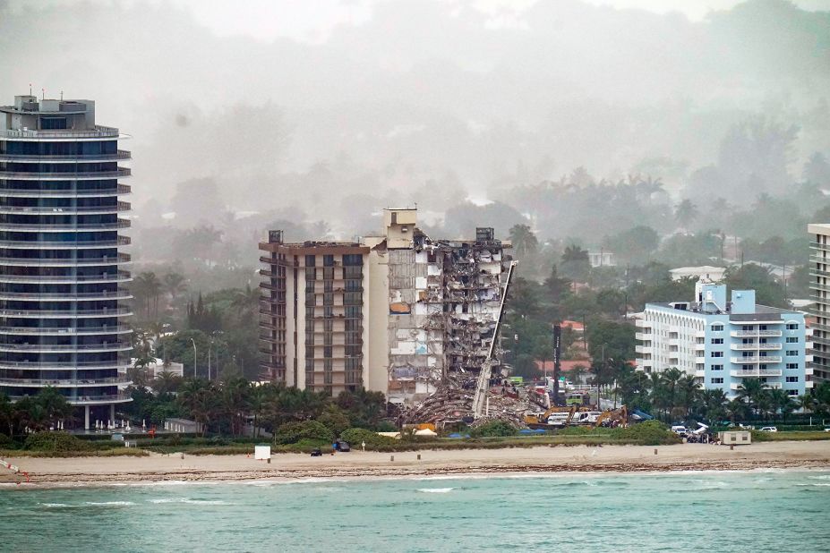 Workers search through the rubble on June 26.