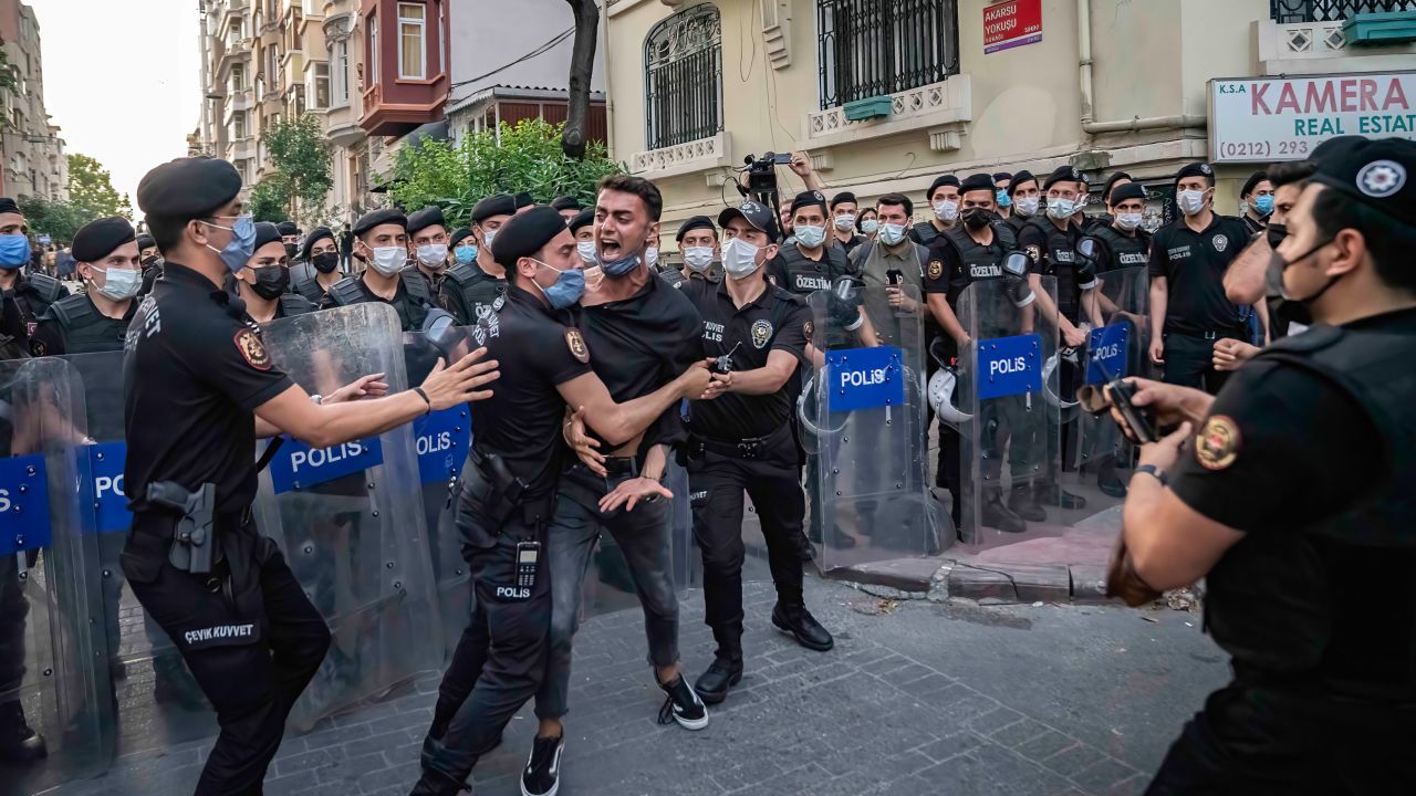 Police officers detain a protester as LGBT activists defied a ban and tried to stage a Pride event in central Istanbul on June 26, 2021. 