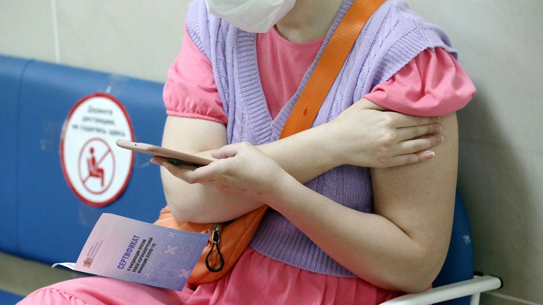 A woman is pictured with a vaccination certificate after receiving a shot in the city of Ivanovo on June 18. 