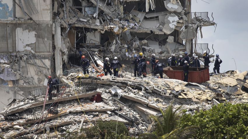 SURFSIDE, FLORIDA - JUNE 26: Members of the South Florida Urban Search and Rescue team look for possible survivors in the partially collapsed 12-story Champlain Towers South condo building on June 26, 2021 in Surfside, Florida. Over 150 people are being reported as missing as search-and-rescue efforts continue with rescue crews from across Miami-Dade and Broward counties. (Photo by Joe Raedle/Getty Images)