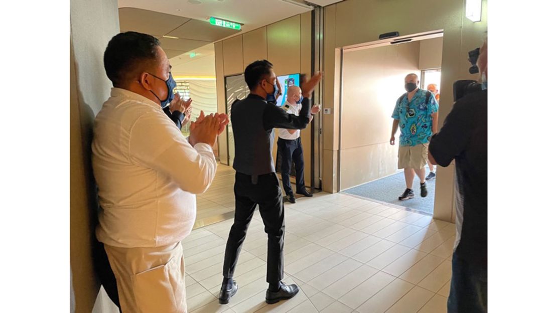 Celebrity Edge crew welcome passengers aboard.