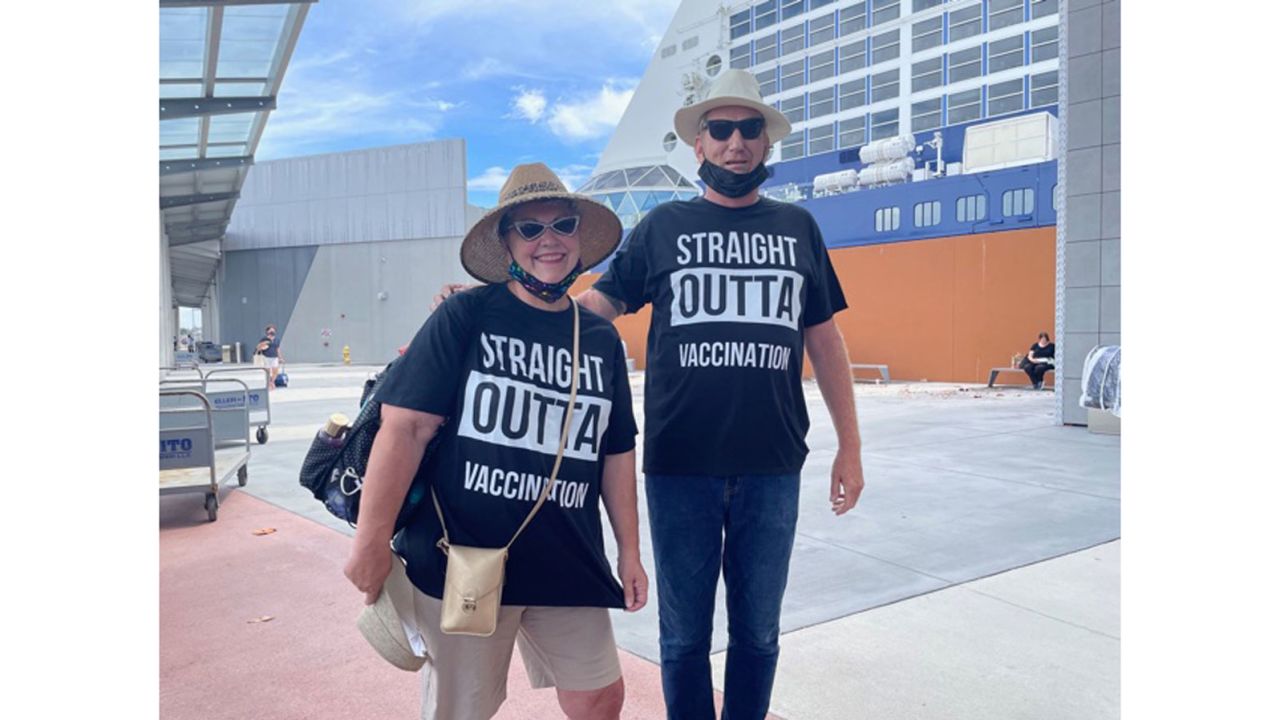 "I think it's good that Celebrity has got their folks back to working and ready to sail," said Cynthia Mitchell of Hope, Kansas, wearing matching "Straight Outta Vaccination" shirts with her husband, James.