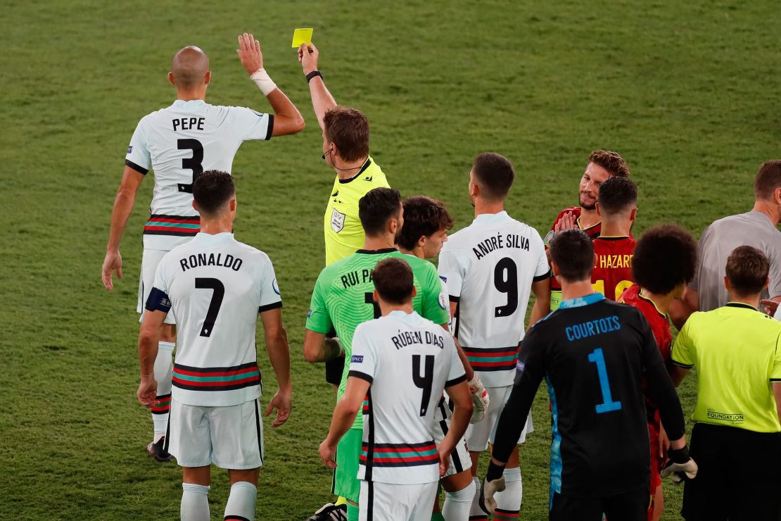 Pepe receives a yellow card for a challenge on Belgium's Hazard.