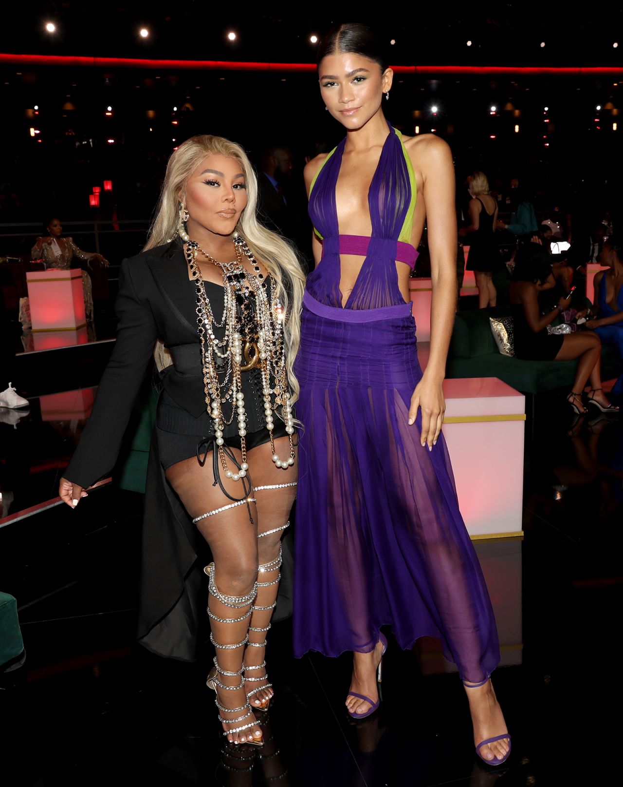 Zendaya wearing a 2003 Versace dress as she poses with rapper Lil Kim at the BET Awards.