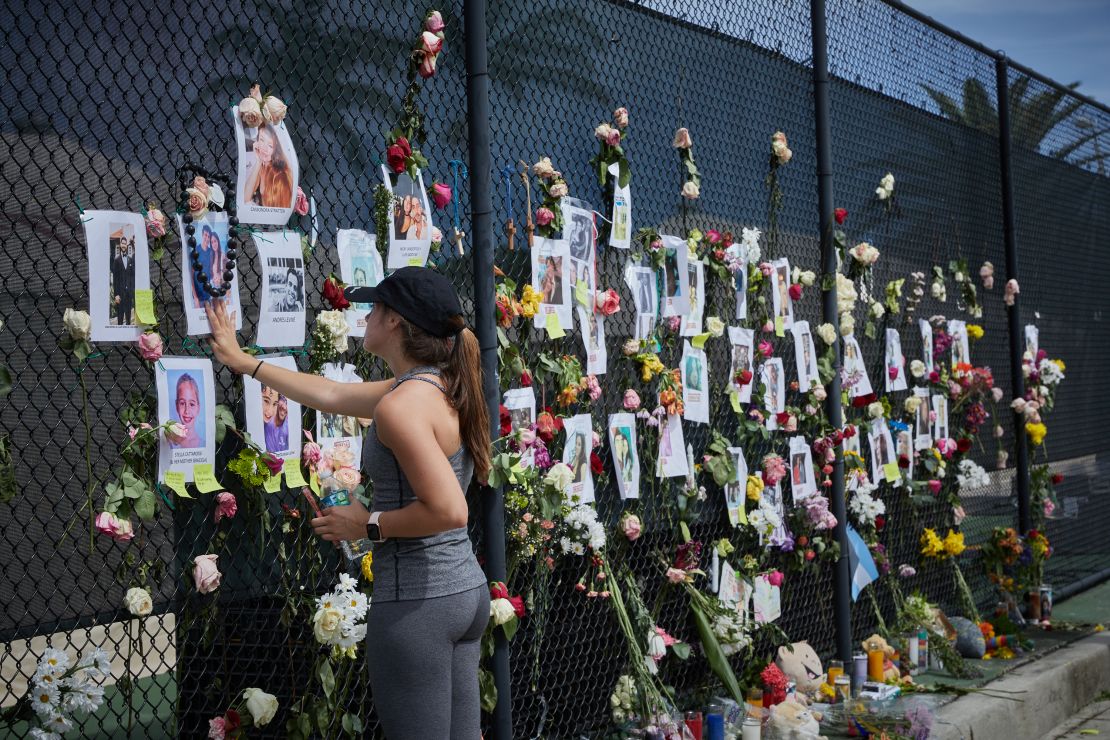 Residents, friends and relatives visit the memorial wall of photos and flowers for the missing near the site of the collapse.