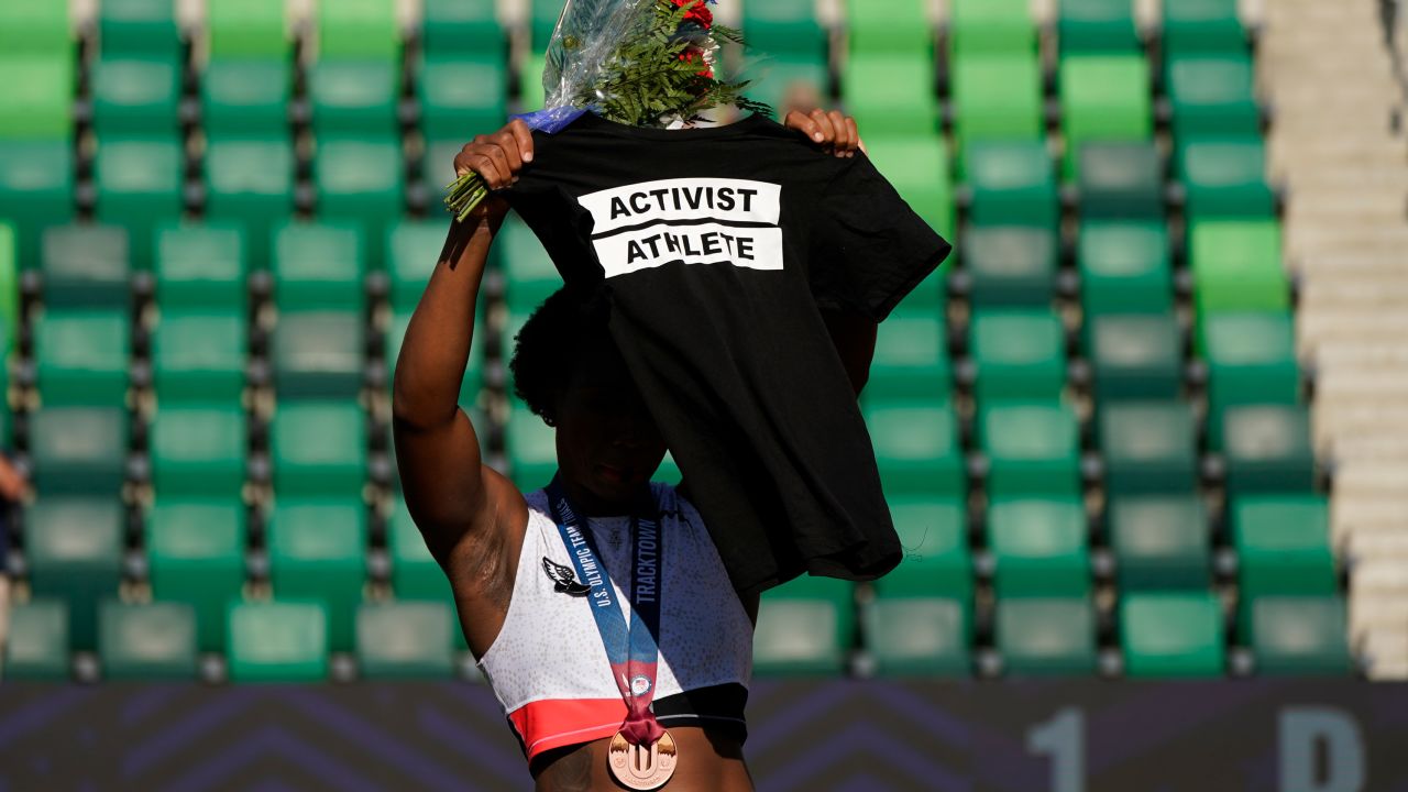 Berry displays a T-shirt on the podium at the Olympic trials.
