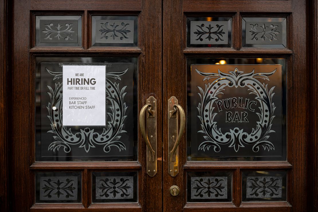 A hiring sign is seen in the window of a pub in Westminster on June 4, 2021 in London, England. Demand for workers in the hospitality sector has increased significantly following the easing of coronavirus restrictions, but many businesses are struggling to find staff. 