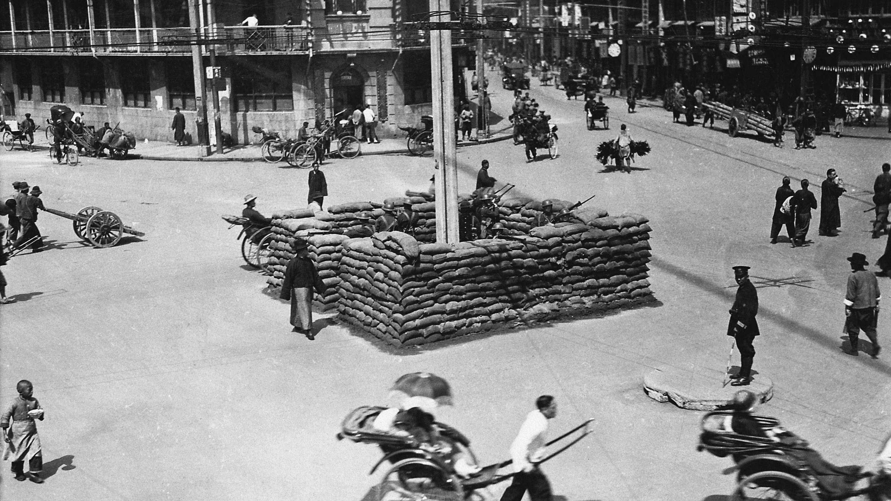 British troops guard a barricade on a street in Shanghai, China, in 1927. That year, the Kuomintang, or Chinese Nationalist Party, purged the Communist party in Shanghai, leading to a civil war between the Communists and Nationalists that would last more than 20 years. Thousands died in what the Nationalists called the "cleansing of the party." 