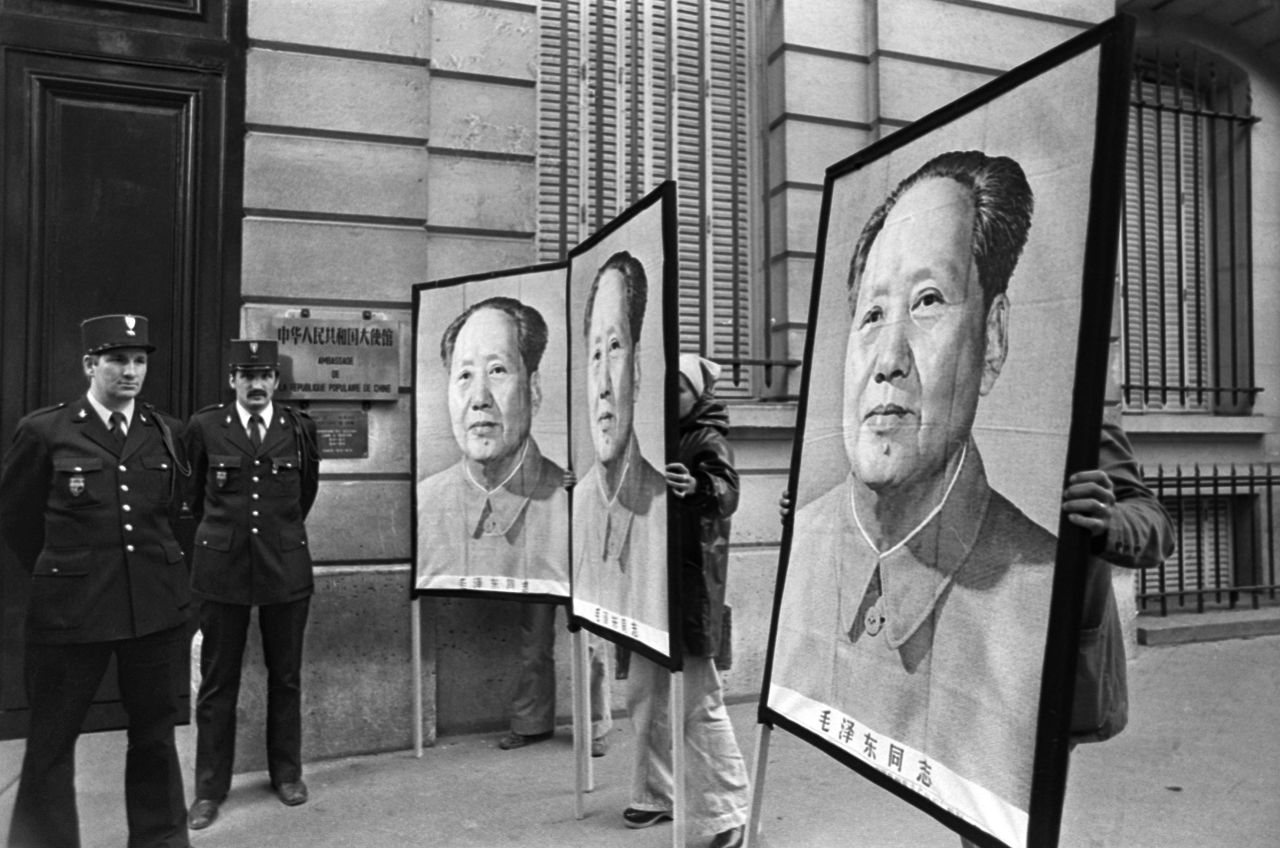 People hold portraits of Mao in front of the Chinese Embassy in Paris after his death on September 9, 1976. He was 82.