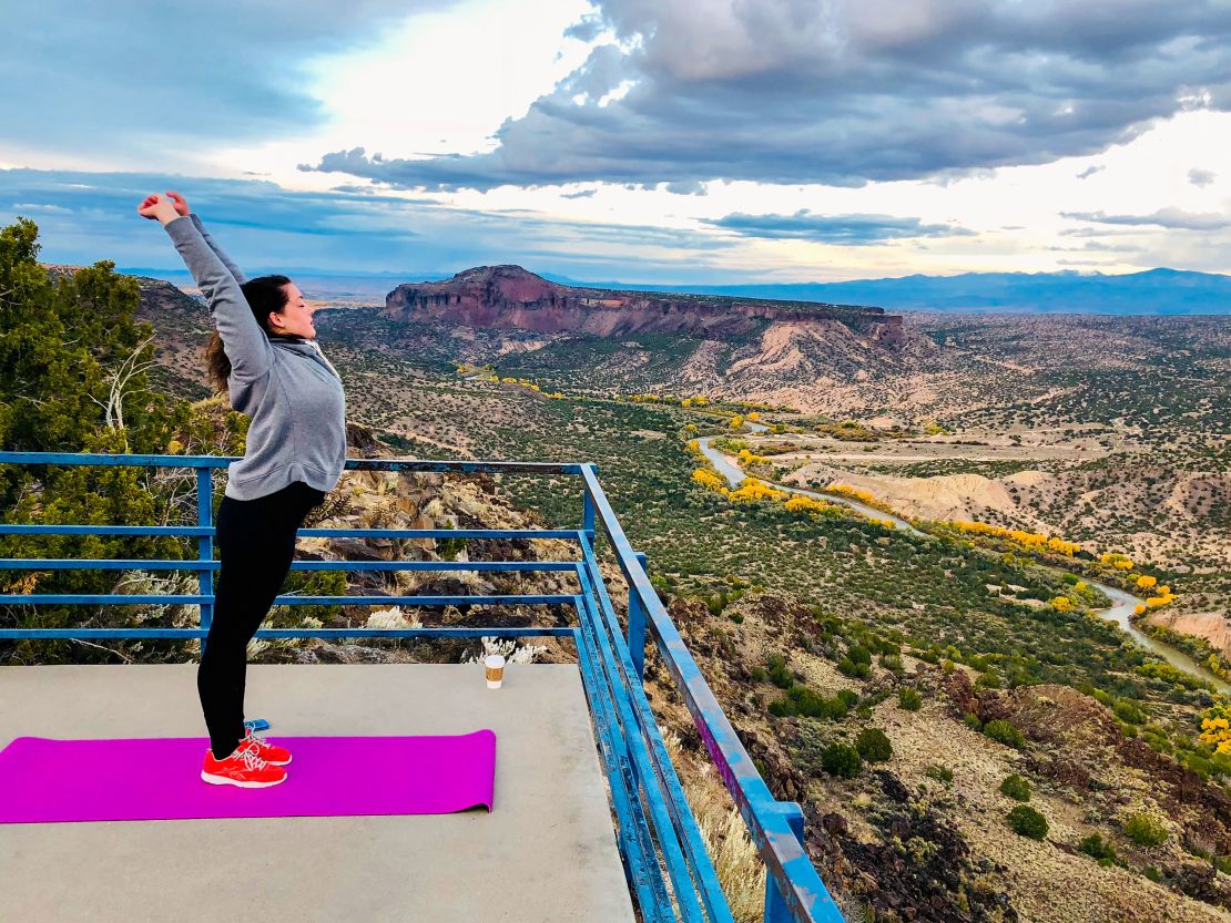 A woman stretches atop a lookout in Los Alamos County, New Mexico.