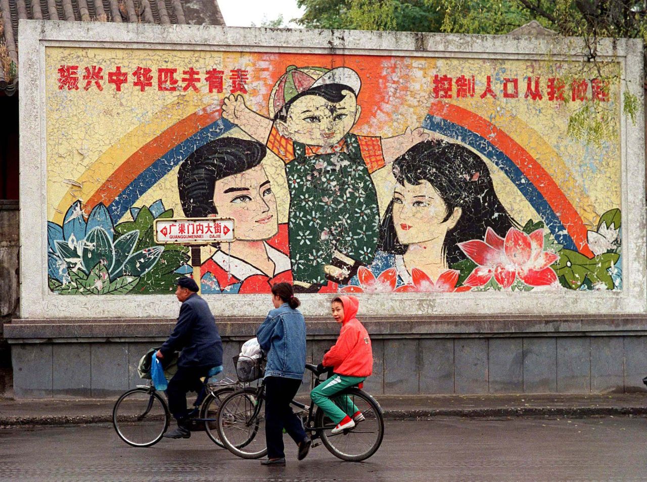 A decaying mural promoting China's one-child family policy is seen on a street in Beijing in 1996. The one-child policy was introduced in 1979 when the government feared a rapid increase in population size after the baby boom of the 1950s and 1960s. The country's fertility rate fell dramatically, from a peak of almost six births for every woman between 1960 and 1965 to 1.5 between 1995 and 2014. In 2015, <a href="https://www.cnn.com/2016/10/13/health/china-one-child-policy-population-growth/index.html" target="_blank">China decided to overturn the decades-old policy</a> and allow couples across the country to have two children. In 2021, the government <a href="https://www.cnn.com/2021/05/31/china/china-three-child-policy-intl-hnk/index.html" target="_blank">announced it would allow couples to have three children,</a> but it's unclear when the new policy will take effect.