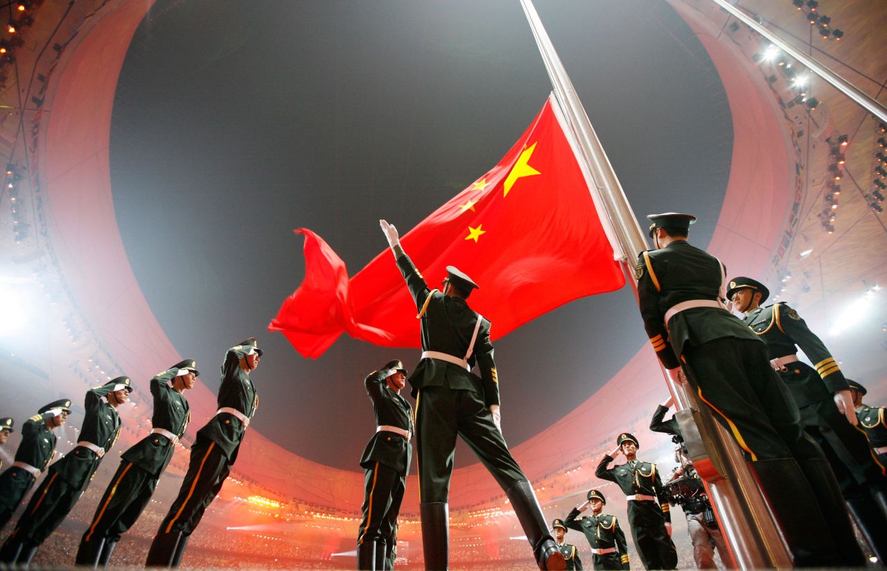 China's flag is raised during the opening ceremony of the 2008 Summer Olympics, which were held in Beijing. China had never hosted the Olympics before, and in the run-up to the 2008 Games — held under the slogan "One World, One Dream" — <a href="https://www.cnn.com/2021/02/21/asia/beijing-olympics-2008-2022-soft-power-dst-intl-hnk/index.html" target="_blank">there were calls for a boycott</a> over the country's human-rights record.