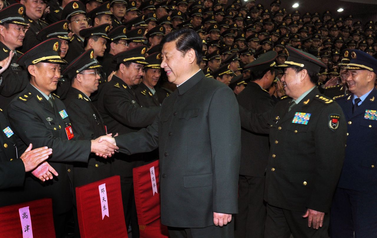 Xi shakes hands with army delegates in Beijing in December 2012.