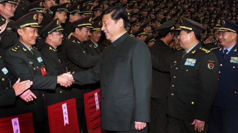 Xi shakes hands with army delegates in Beijing in December 2012.